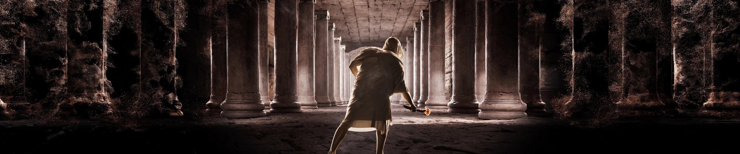 A hooded figure with a torch walking between dissolving columns