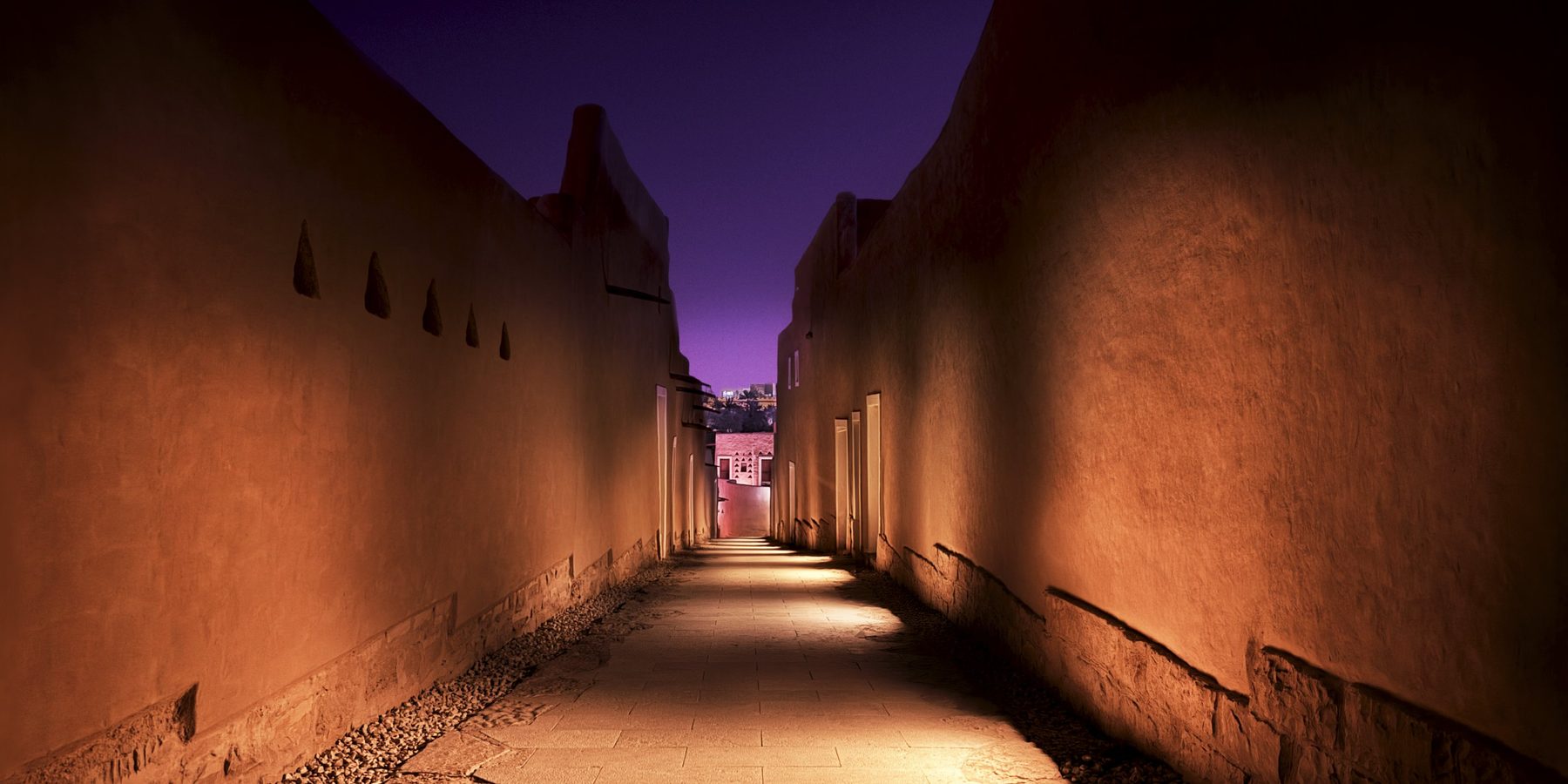 The photographed Diriyah alley, warmly lit